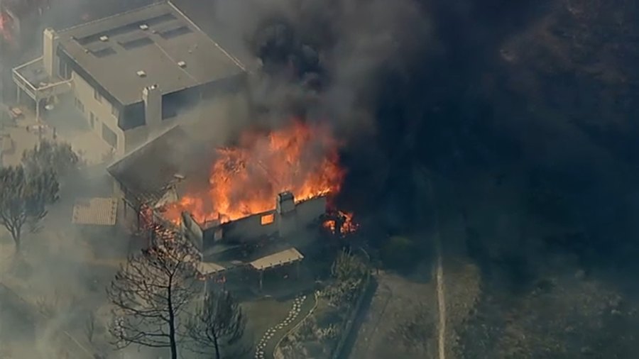 Aerial view of a home burning in the Norte Fire