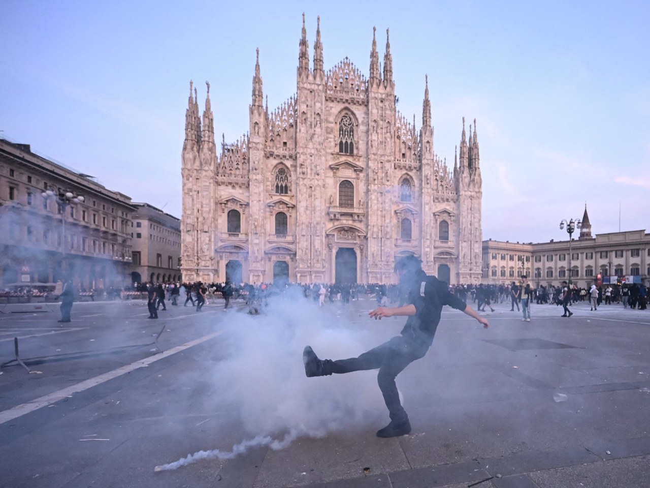 Protester near Piazza Duomo in Milan amid tear gas