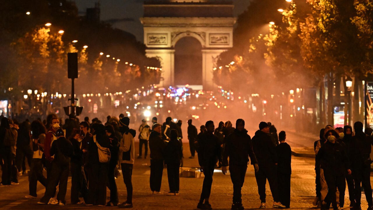 Crowds on the Champs-Elysees in Paris at dusk