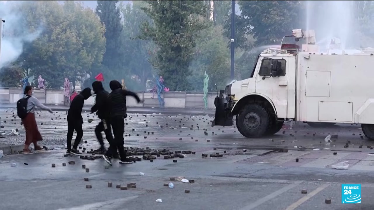 Protesters and a water-cannon truck in Tirana